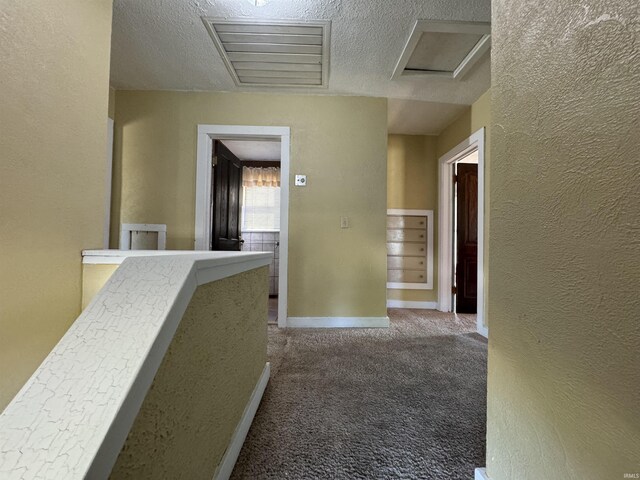 232 S Main St, Avilla, IN 46710 - hall with a textured ceiling, carpet, baseboards, attic access, and a textured wall