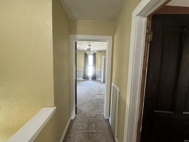 232 S Main St, Avilla, IN 46710 - hall with carpet floors, a textured wall, baseboards, and a textured ceiling