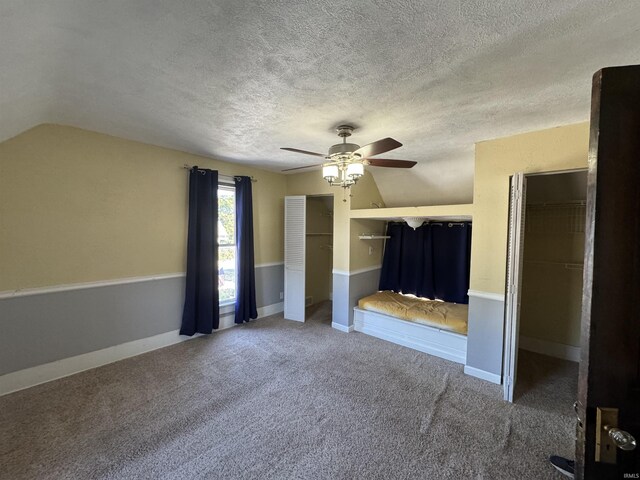 232 S Main St, Avilla, IN 46710 - unfurnished bedroom featuring vaulted ceiling, carpet floors, a textured ceiling, baseboards, and ceiling fan