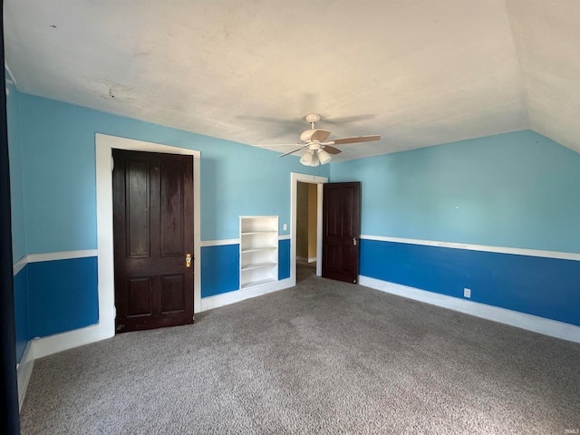 unfurnished bedroom featuring carpet floors, vaulted ceiling, ceiling fan, and a closet