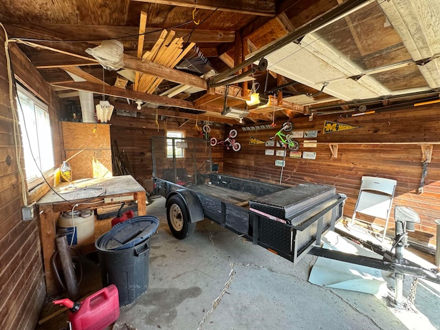 garage with a garage door opener and wooden walls