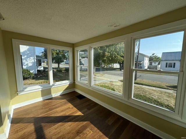 232 S Main St, Avilla, IN 46710 - sunroom featuring visible vents, a textured ceiling, baseboards, and wood finished floors