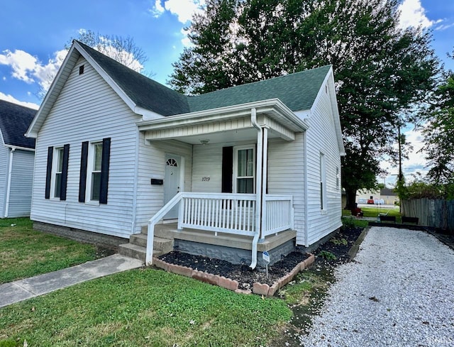 view of front of home with covered porch and a front yard