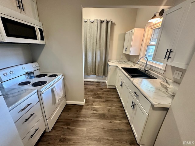 kitchen featuring white cabinets, white appliances, light stone countertops, dark hardwood / wood-style floors, and sink