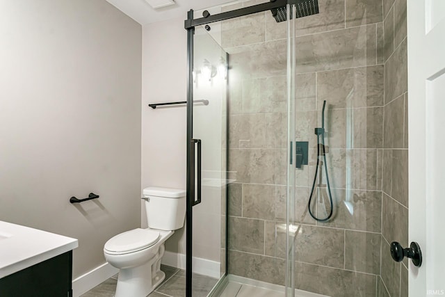 bathroom featuring an enclosed shower, vanity, and toilet