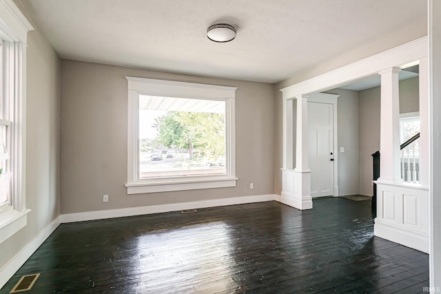 spare room with dark hardwood / wood-style flooring