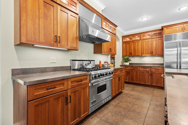 kitchen with crown molding, premium appliances, and wall chimney range hood