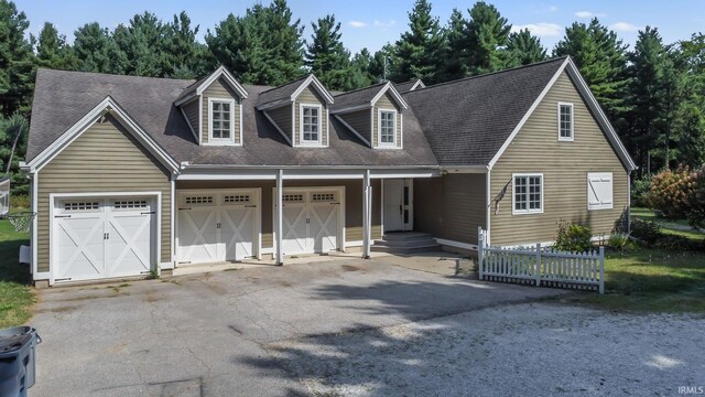 cape cod-style house featuring a garage