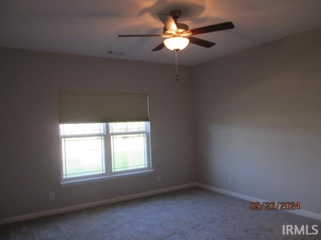 spare room with ceiling fan and carpet flooring