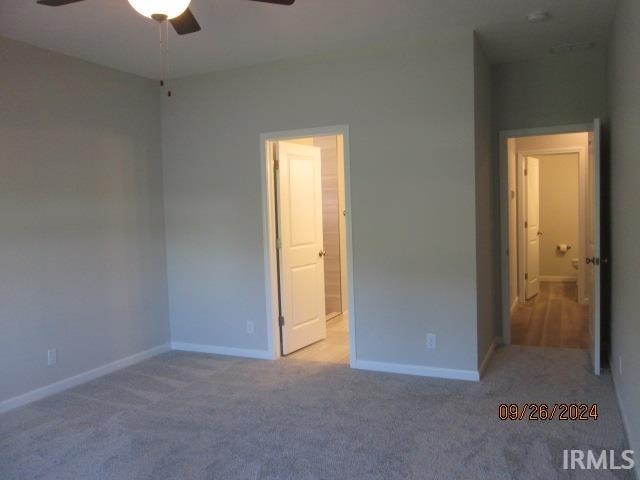 unfurnished bedroom featuring carpet and ceiling fan