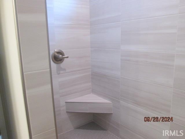 bathroom with tiled shower