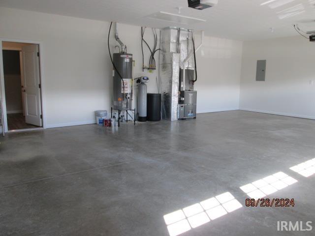 2159 Maple Leaf Dr, Kokomo, IN 46902 - garage featuring gas water heater, electric panel, a garage door opener, heating unit, and baseboards