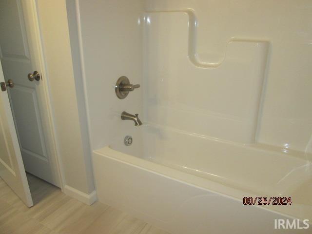 2159 Maple Leaf Dr, Kokomo, IN 46902 - bathroom with wood finished floors, baseboards, and bathing tub / shower combination