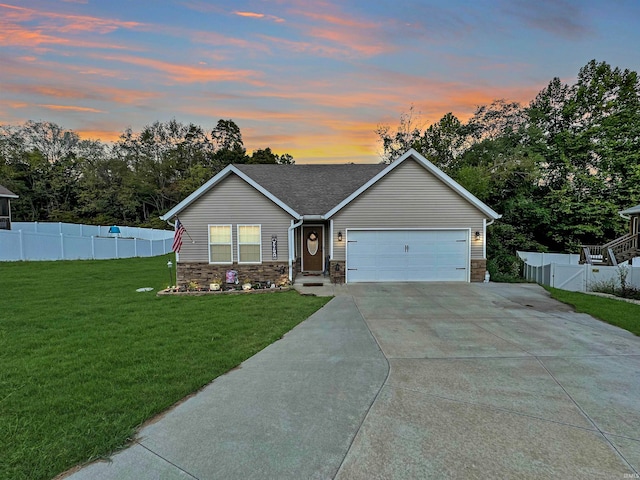 view of front of home with a lawn and a garage