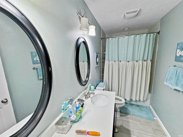 full bathroom featuring hardwood / wood-style floors, vanity, toilet, and shower / bath combo with shower curtain