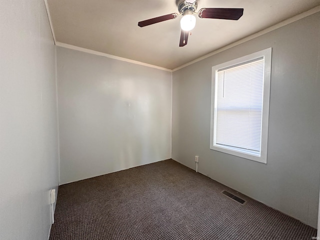 unfurnished room with crown molding, dark colored carpet, and ceiling fan