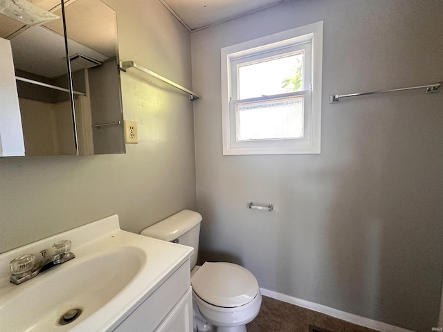 bathroom with tile patterned flooring, vanity, and toilet