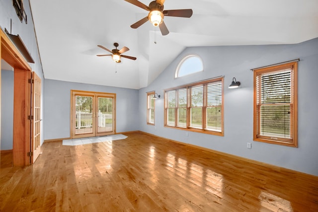 unfurnished living room featuring light wood-type flooring, lofted ceiling, ceiling fan, and french doors