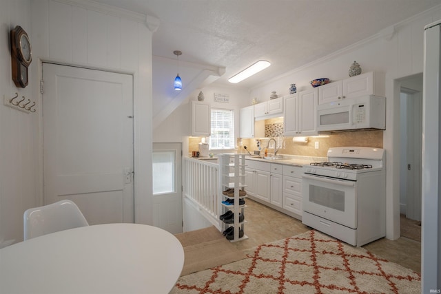 kitchen with crown molding, white cabinets, hanging light fixtures, and white appliances