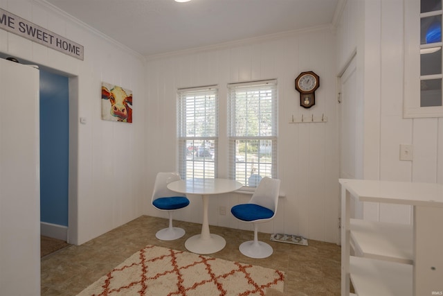 unfurnished dining area with crown molding and wooden walls