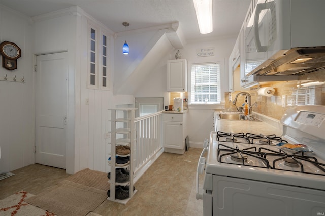 kitchen with decorative backsplash, white cabinets, ornamental molding, sink, and white appliances