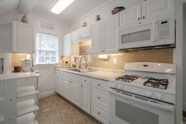 kitchen with white cabinets, tasteful backsplash, sink, and white appliances