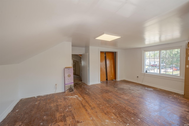 unfurnished living room with lofted ceiling and dark hardwood / wood-style floors