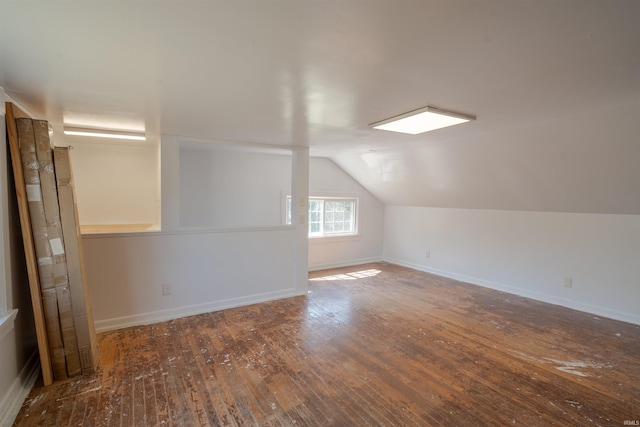 bonus room with lofted ceiling and dark hardwood / wood-style floors