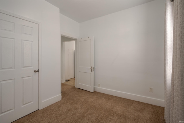 unfurnished bedroom with light colored carpet