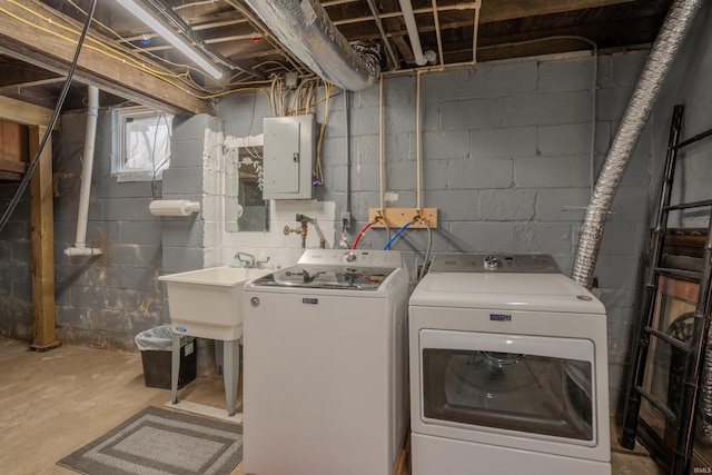 washroom with independent washer and dryer, electric panel, and sink