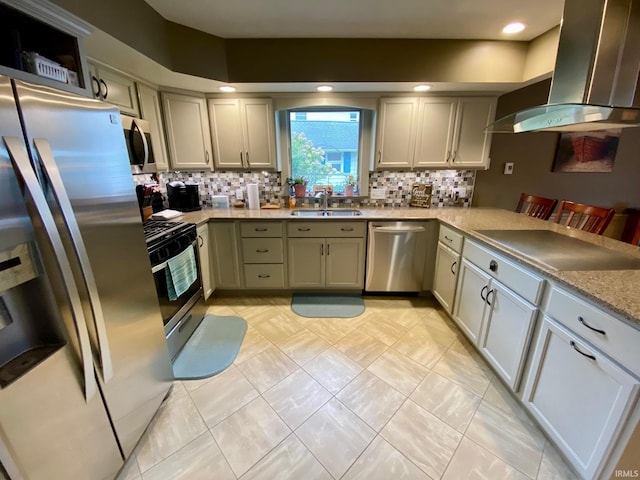 kitchen with sink, appliances with stainless steel finishes, tasteful backsplash, and wall chimney range hood