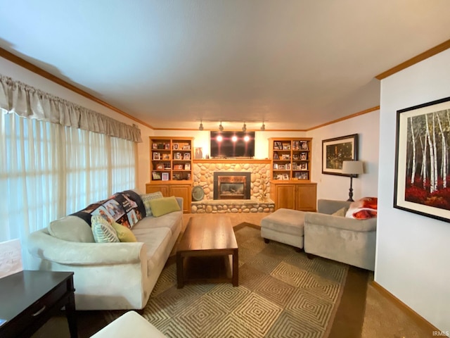 carpeted living room featuring crown molding, a stone fireplace, track lighting, and built in features