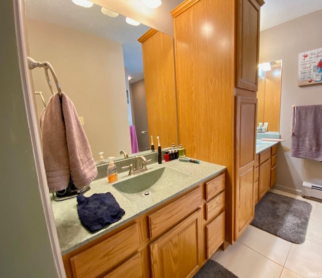 bathroom with vanity, a baseboard radiator, and tile patterned flooring