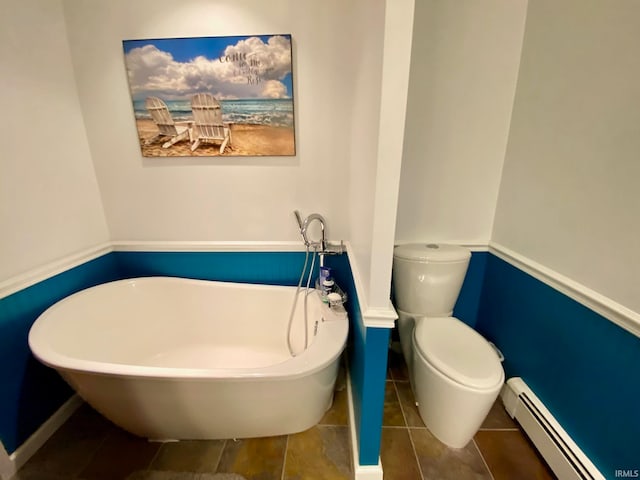 bathroom featuring a bathtub, toilet, tile patterned floors, and a baseboard radiator