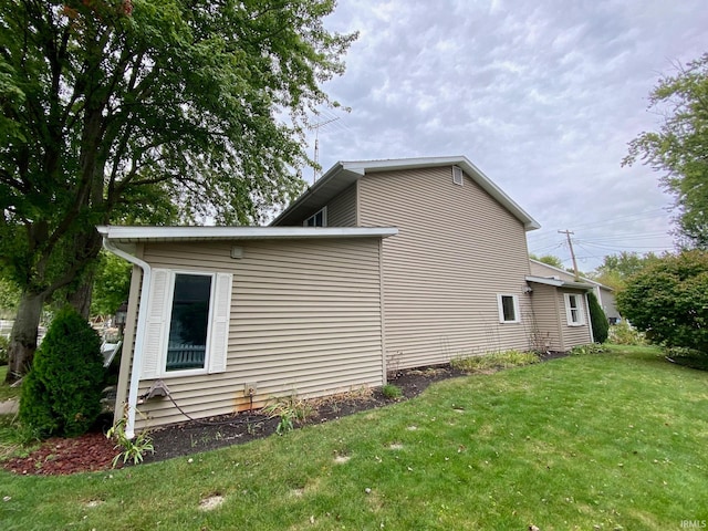 view of home's exterior featuring a lawn