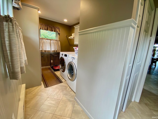 laundry room with cabinets, light tile patterned flooring, and independent washer and dryer