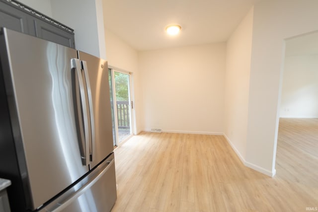 kitchen with light hardwood / wood-style floors and stainless steel refrigerator