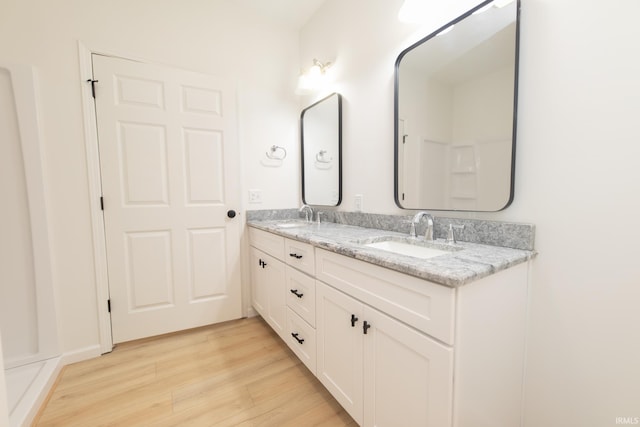 bathroom with vanity and hardwood / wood-style floors