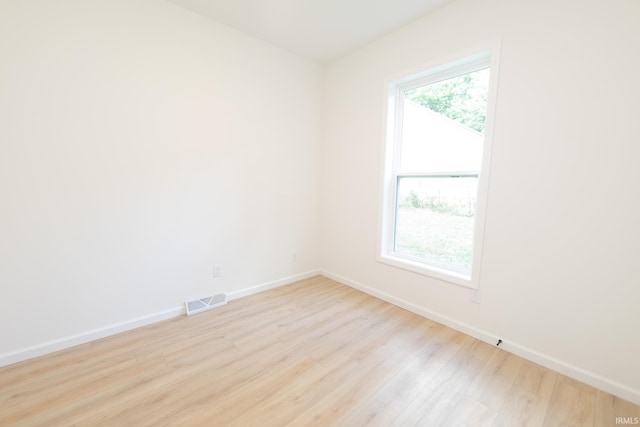 spare room with light hardwood / wood-style floors