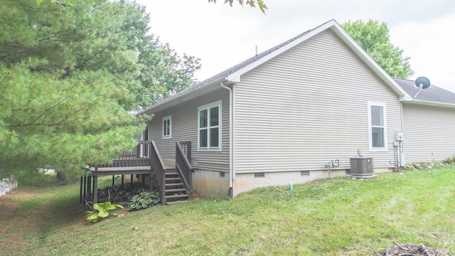 view of property exterior with a yard and central air condition unit