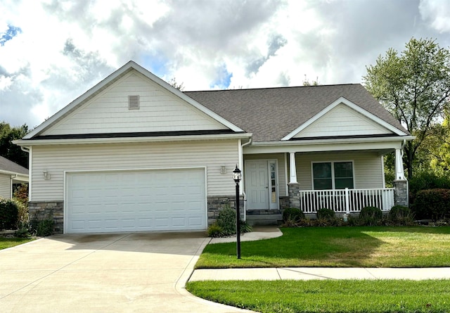 craftsman house featuring a front yard, a garage, and covered porch