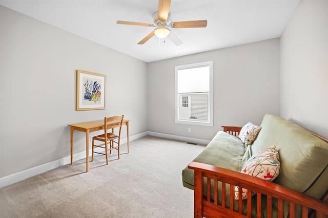 living area with ceiling fan and light colored carpet