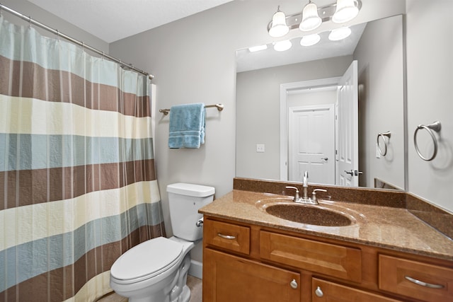 bathroom with curtained shower, vanity, and toilet