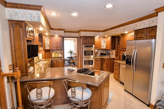 kitchen featuring a kitchen breakfast bar, kitchen peninsula, light tile patterned floors, stainless steel appliances, and ornamental molding