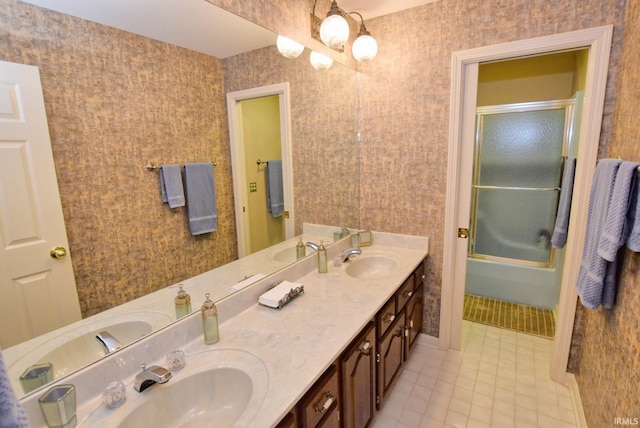 bathroom with tile patterned flooring, enclosed tub / shower combo, and vanity