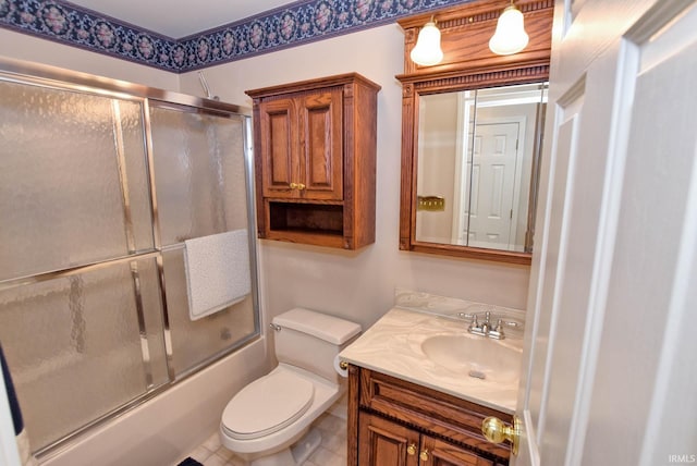 full bathroom featuring enclosed tub / shower combo, vanity, toilet, and tile patterned floors