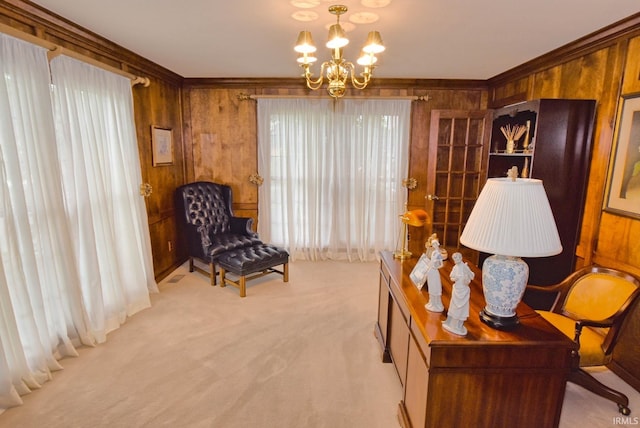 sitting room featuring light carpet, wood walls, a chandelier, and crown molding