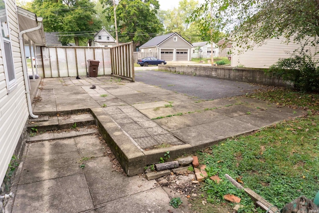 view of patio featuring an outdoor structure and a garage