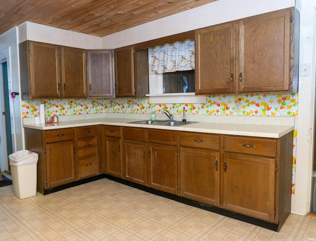 kitchen featuring wood ceiling and sink