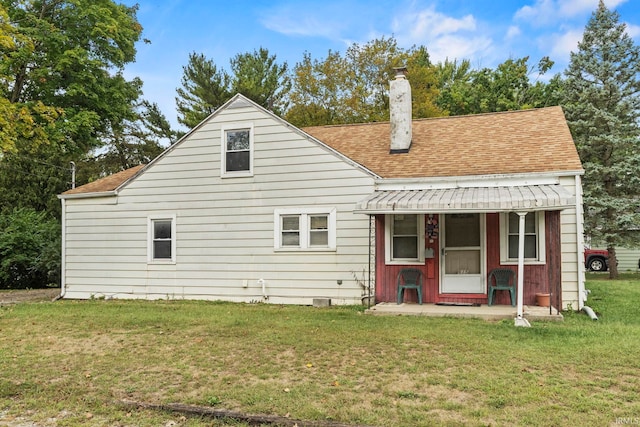 back of property featuring a yard